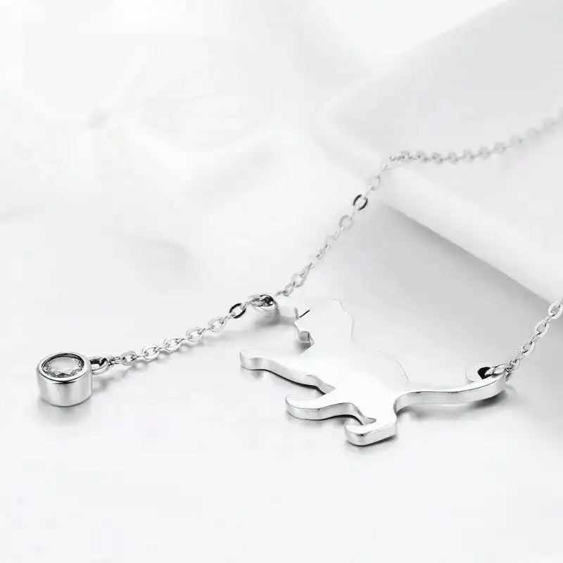 Detail image of silver colored cat-shaped necklace with cubic zirconia