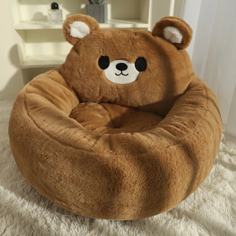 Brown teddy bear-shaped cat bed on a white rug