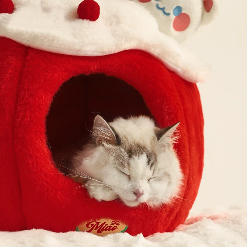Cat sleeping in a red cat bed with a Miao logo