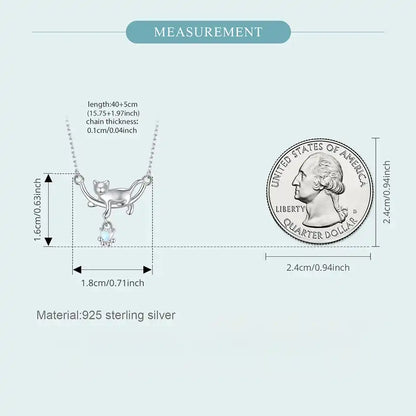 Measurement chart of a silver necklace with a coin for scale on a light gray background