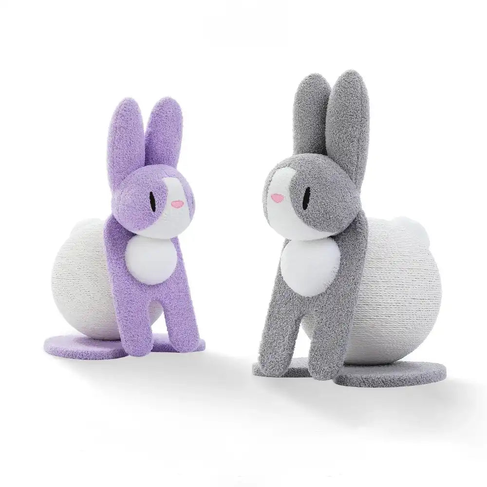 Two bunny-shaped cat scratchers, one purple and one gray, standing on a white background.