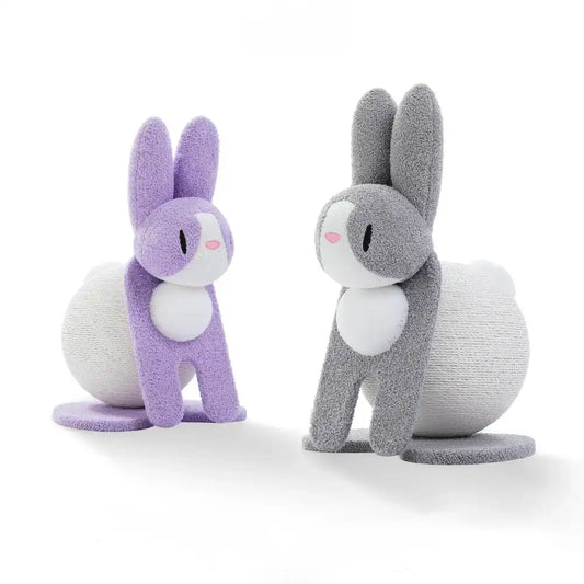 Two bunny-shaped cat scratchers, one purple and one gray, standing on a white background.