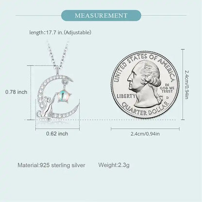 Image of cat and moon necklace alongside a US quarter dollar with measurements and details listed