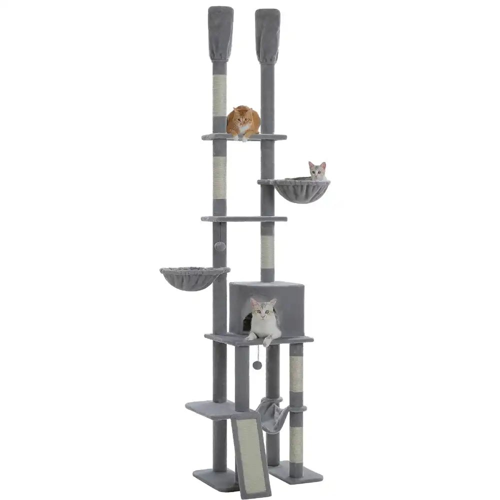 Gray cat tree with various perches and a small cat on a white background