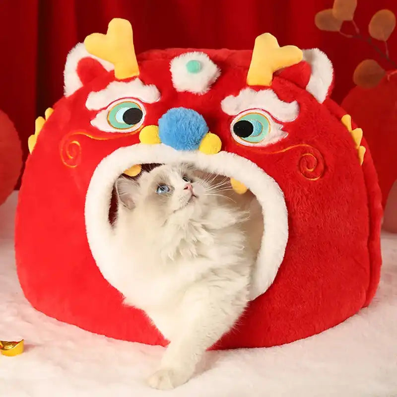 Cat inside a red dragon-shaped pet house with colorful accents on a red background.