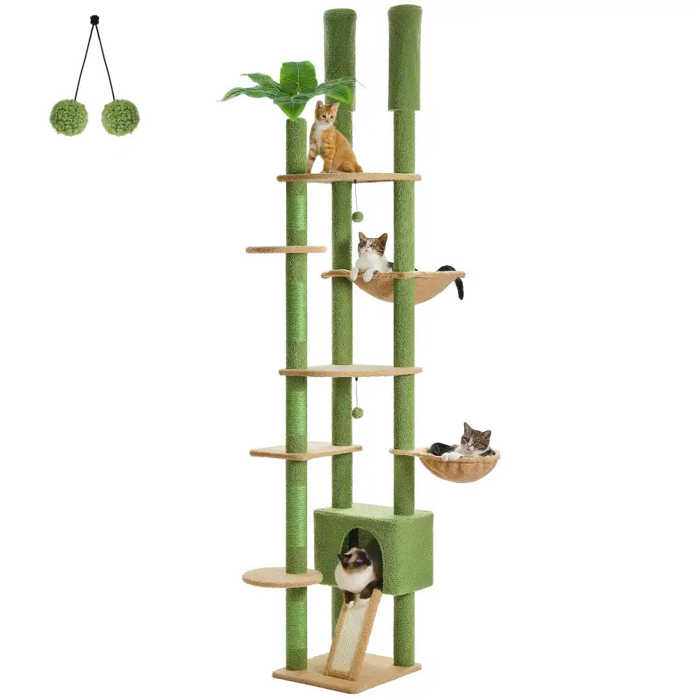 Green cat tree with multiple levels and cat toys on a white background