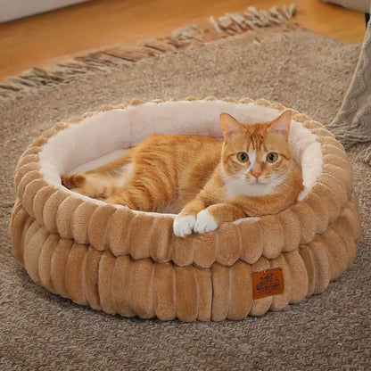 Cat laying in a caramel colored ribbed cat bed in a living room setting