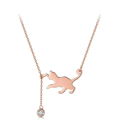Rose gold cat-shaped pendant necklace with a cubic zirconia on a white background