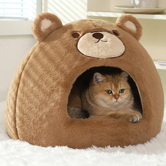 Cat lying inside a brown bear-shaped cat bed on a white rug