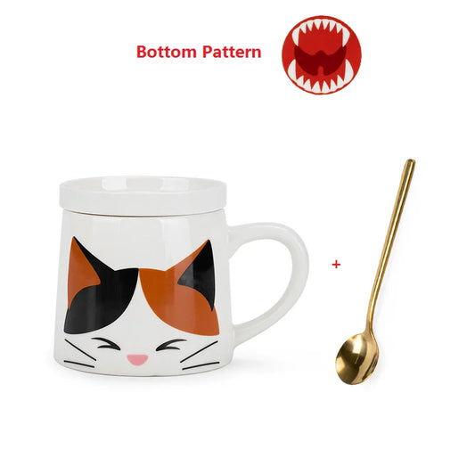 Cat-themed mug with a gold spoon on a white background with image of the base of the mug