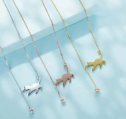 Necklace with cat-shaped pendant with cubic zirconia shown in three colors: gold, rose gold and platinum plated.